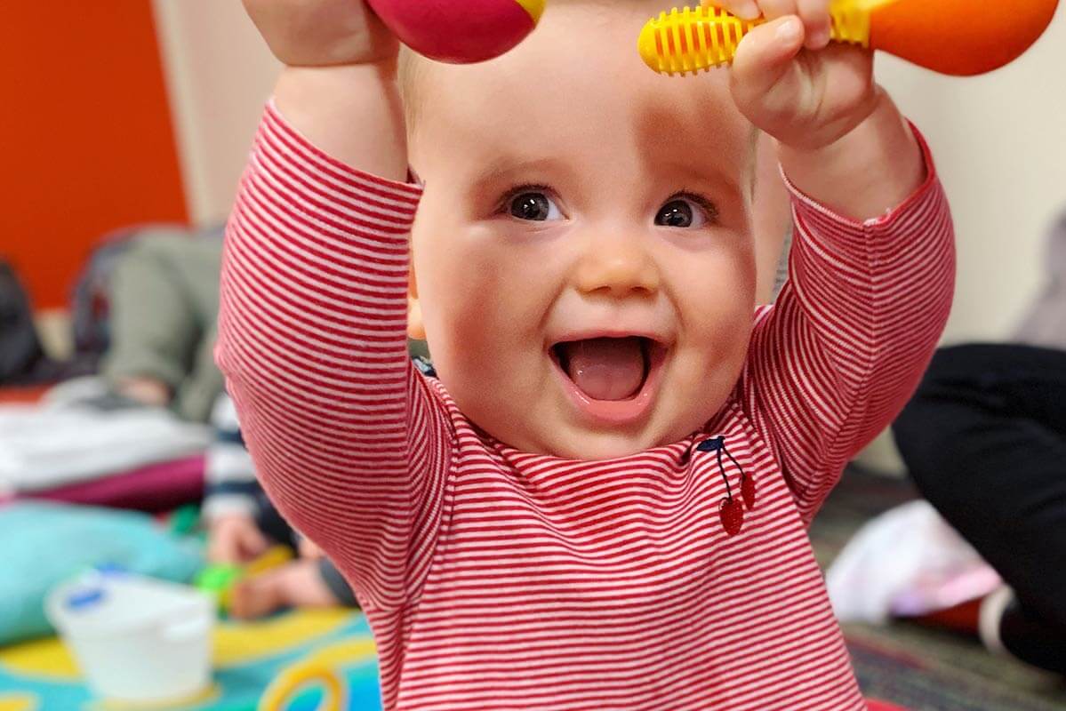 happy-baby-with-sensory-rattles