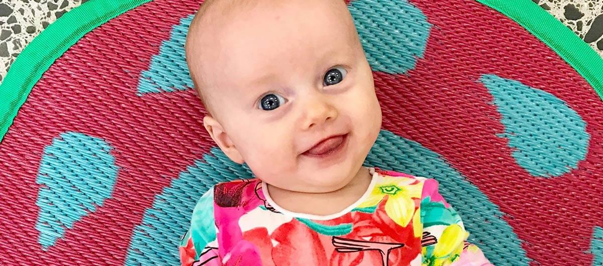 happy baby on a colourful mat