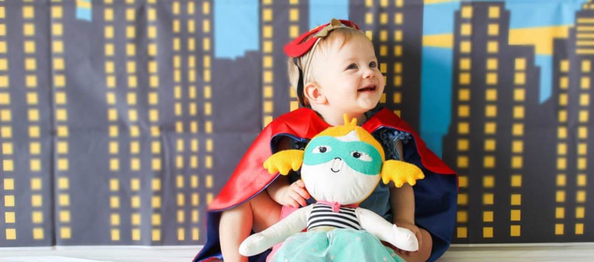 happy toddler boy dressed up as a superhero